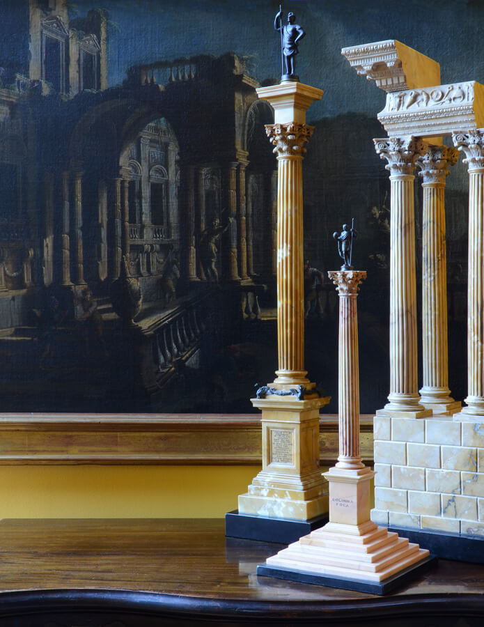 Three large Grand Tour models made of giallo antico, antique yellow Roman marble, before Pietro Cappelli's 18th century capriccio painting with similar columns.